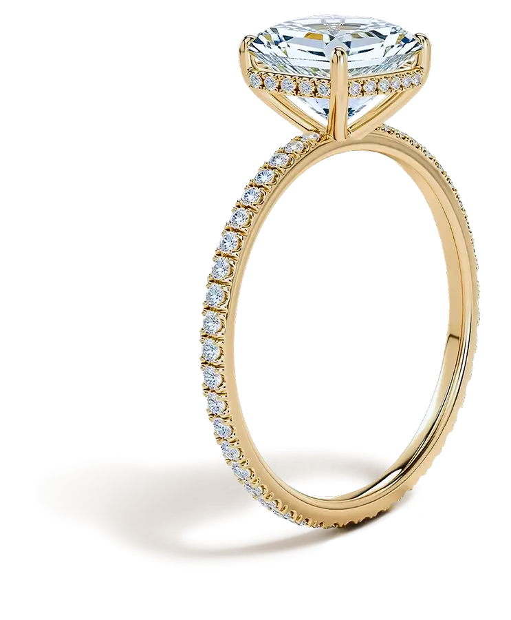 Side view of a gold solitaire engagement ring featuring a round diamond and a pavΓ© diamond band
