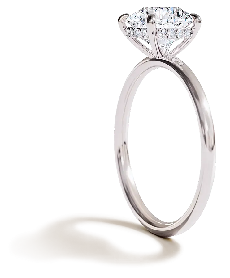 Side view of a platinum solitaire engagement ring featuring a round brilliant-cut diamond