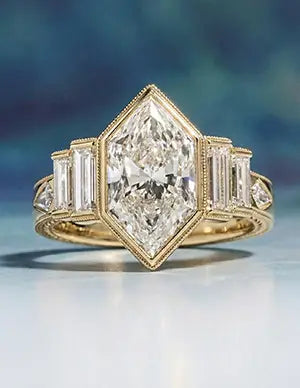 Art Deco gold engagement ring featuring a shield-cut diamond with baguette side stones