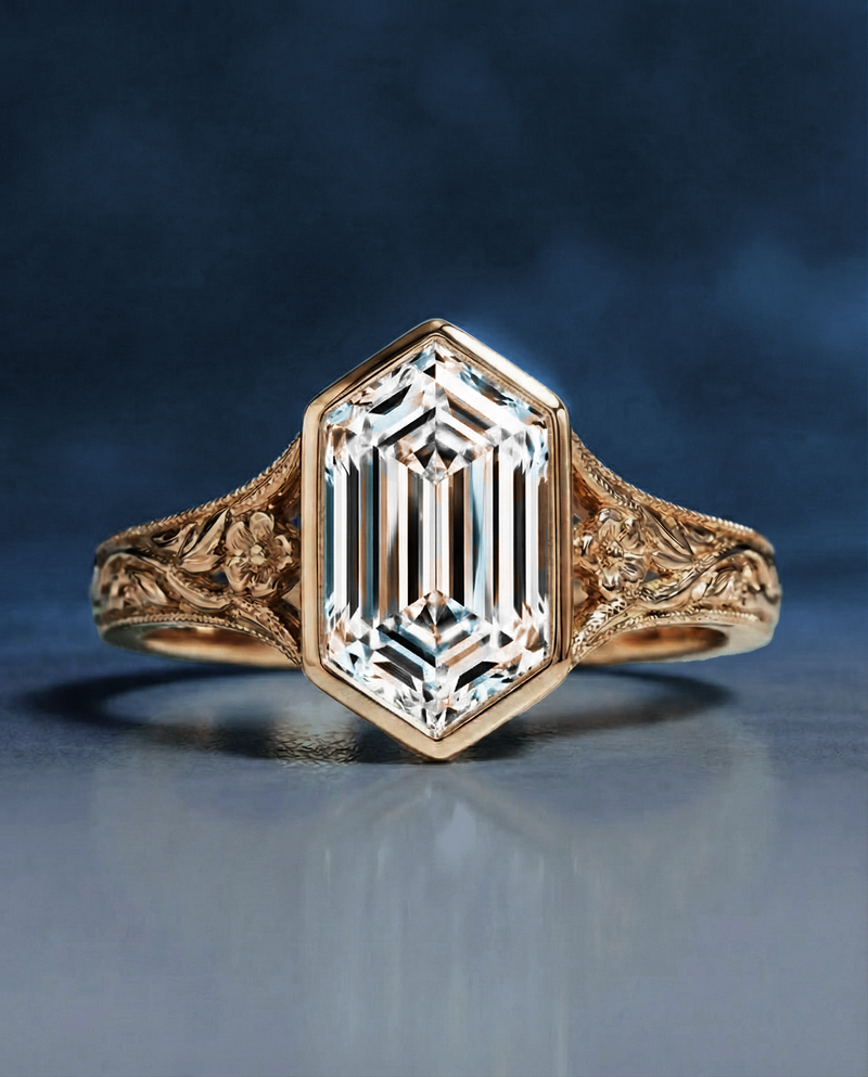 Vintage ring with an emerald-cut diamond set in ornate gold band, featuring intricate floral engravings, exuding elegance and classic charm.