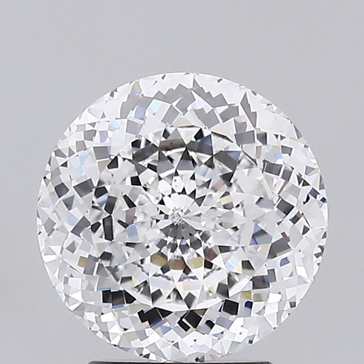 1.02 Close up of a round faceted diamond against a grey background.