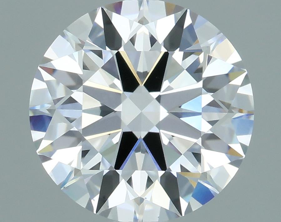 1.06 A round, brilliant-cut diamond sparkling with clear facets and unique black inclusions, set against a soft gray background.