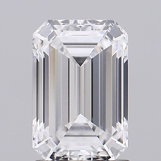 1.56 Emerald-cut diamond with clear facets, sparkling under light, showcasing geometric precision. The background is soft gray, highlighting the gem's clarity.