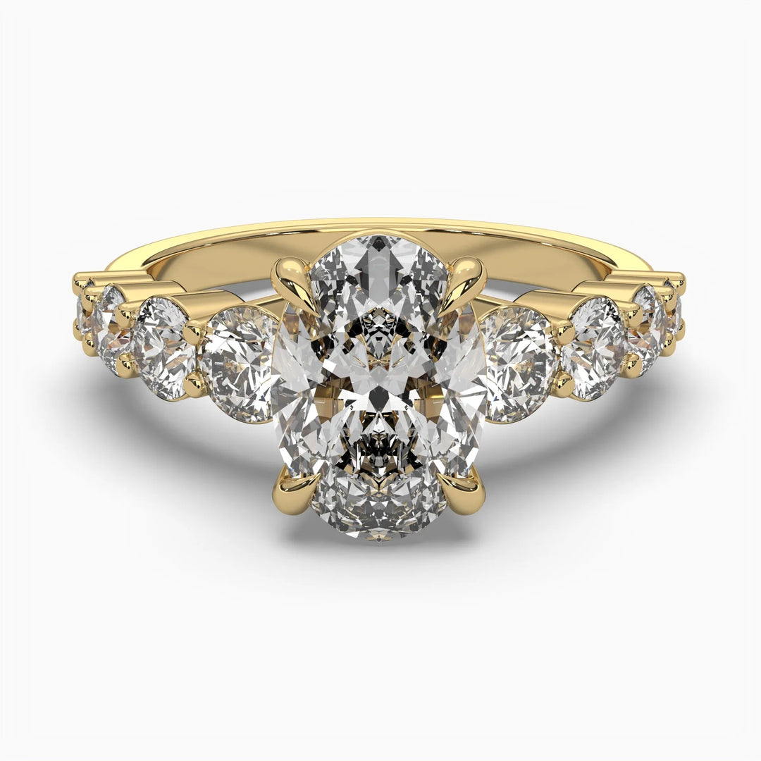 A stunning 14k yellow gold ring featuring a dazzling oval diamond at its center, flanked by smaller round diamonds elegantly lining the band.