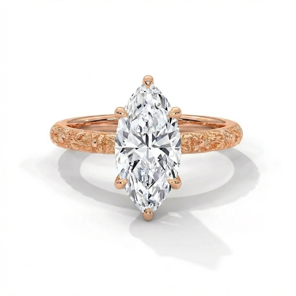 Rose gold ring with a pear-shaped diamond on a white background