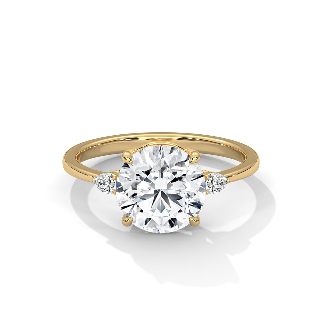 Gold ring with a large diamond and smaller diamonds on the sides against a white background