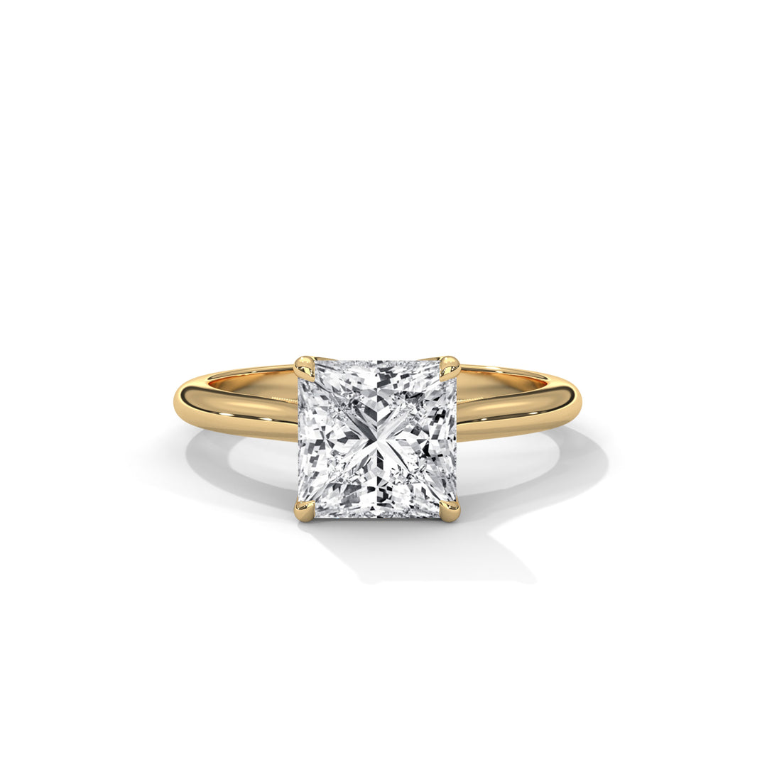 Gold ring with a large diamond on a white background