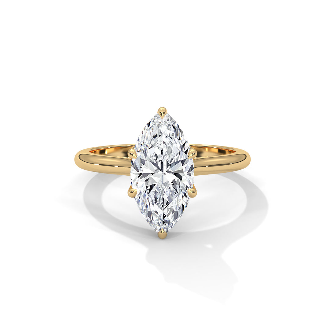 Gold ring with a marquise-shaped diamond on a white background