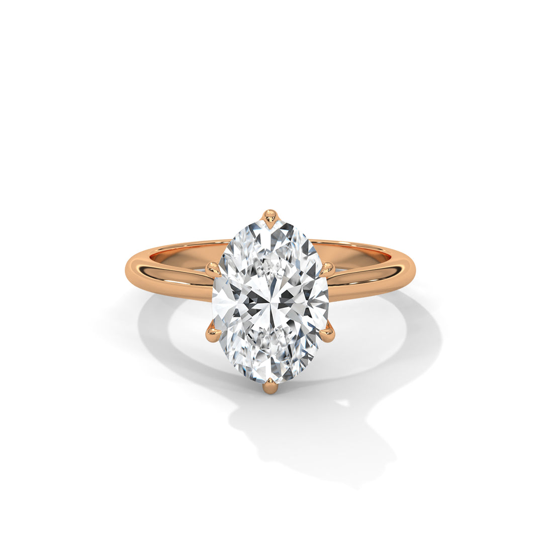 Rose gold ring with a large diamond on a white background