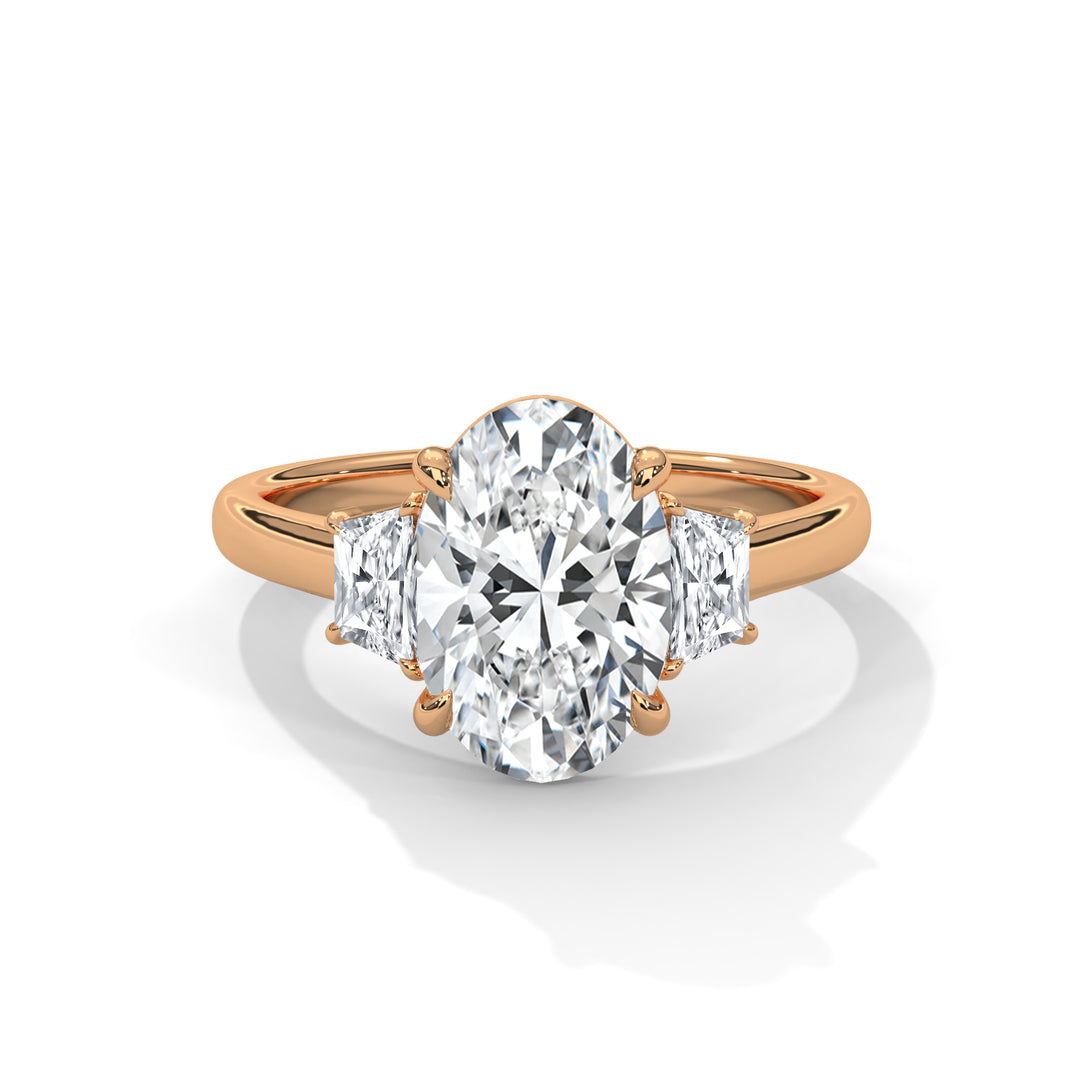 Rose gold ring with a large diamond and two smaller diamonds on a white background