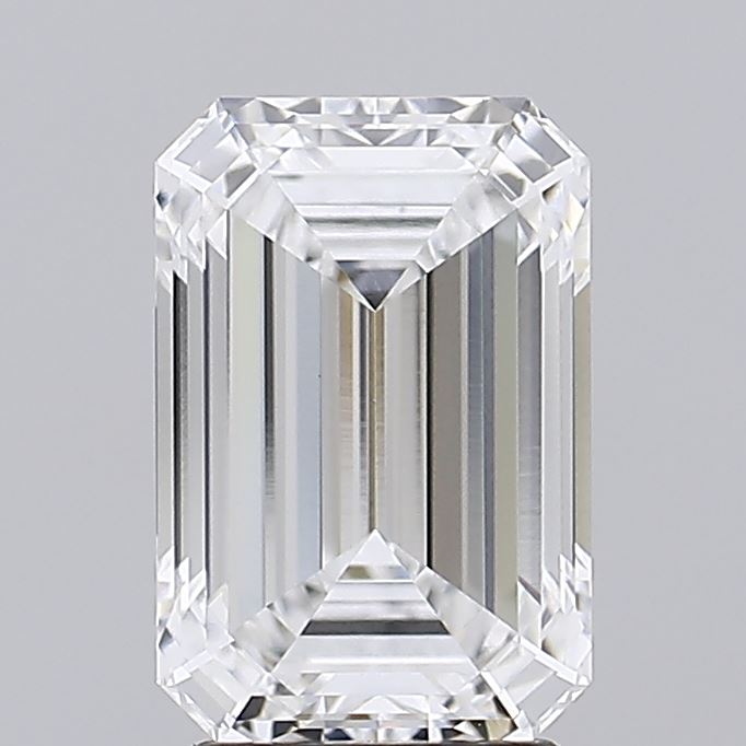 A close-up of a clear emerald-cut diamond against a grey background.