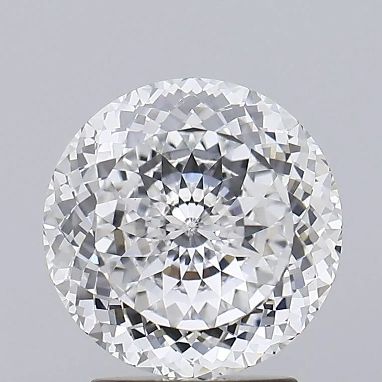 2.53 Close up of a sparkling round diamond showcasing its brilliant facets and clarity against a light grey background.