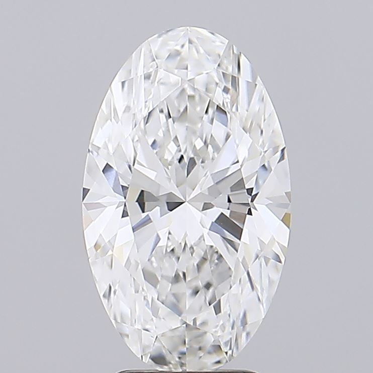2.54 Close-up of a sparkling oval-cut diamond, showcasing its brilliant facets and clarity against a simple gray background.