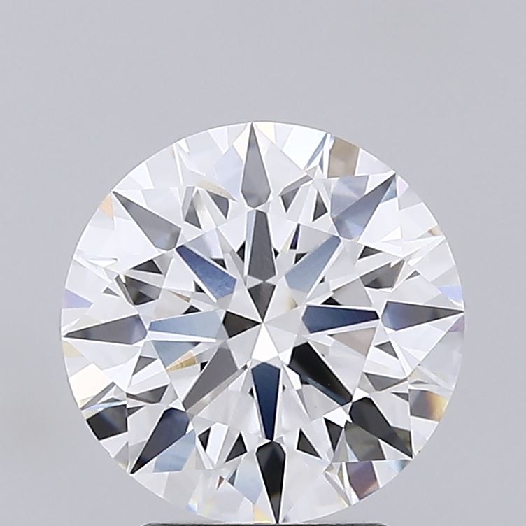 2.72 A brilliant, round-cut diamond against a soft gray background, showcasing intricate facets and a radiant sparkle. The tone is elegant and luxurious.