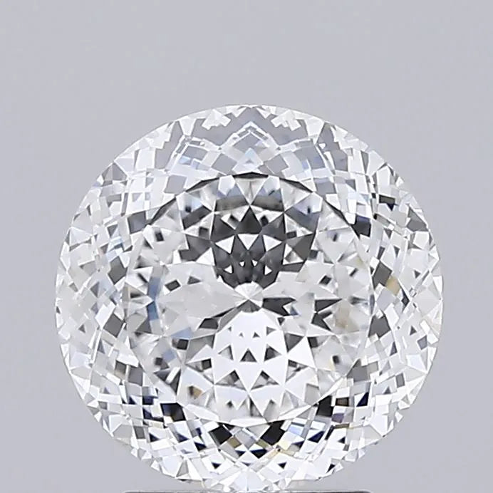 2.73 Close up of a round faceted sparkling clear diamond against a grey background.