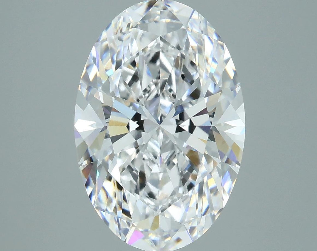 2.96 Close-up of an oval-cut diamond showcasing brilliant facets and sparkling clarity against a soft gray background.