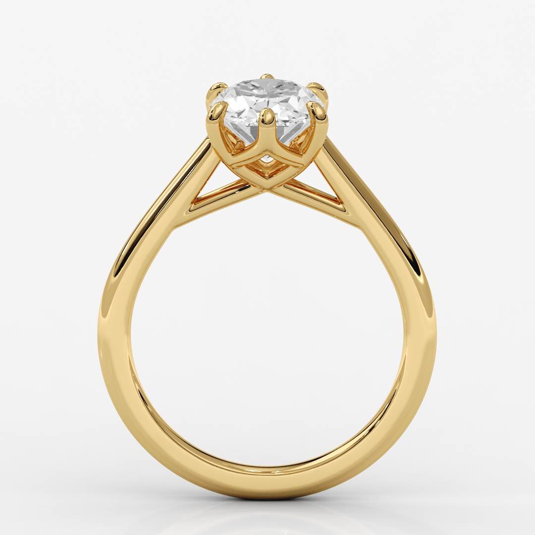 Elegant gold engagement ring with a tapered cathedral setting holding a round brilliant diamond