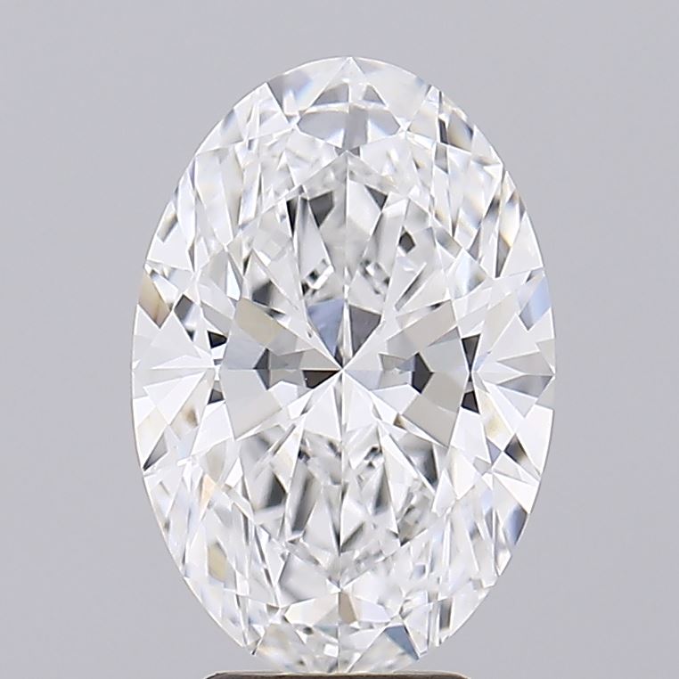 3.03 A sparkling, oval-shaped diamond with intricate facets reflects light brilliantly against a neutral gray background, conveying elegance and luxury.