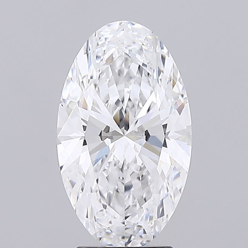 3.09 A sparkling oval-cut diamond is displayed against a plain gray backdrop. The facets are intricately cut, reflecting light and creating a dazzling effect.