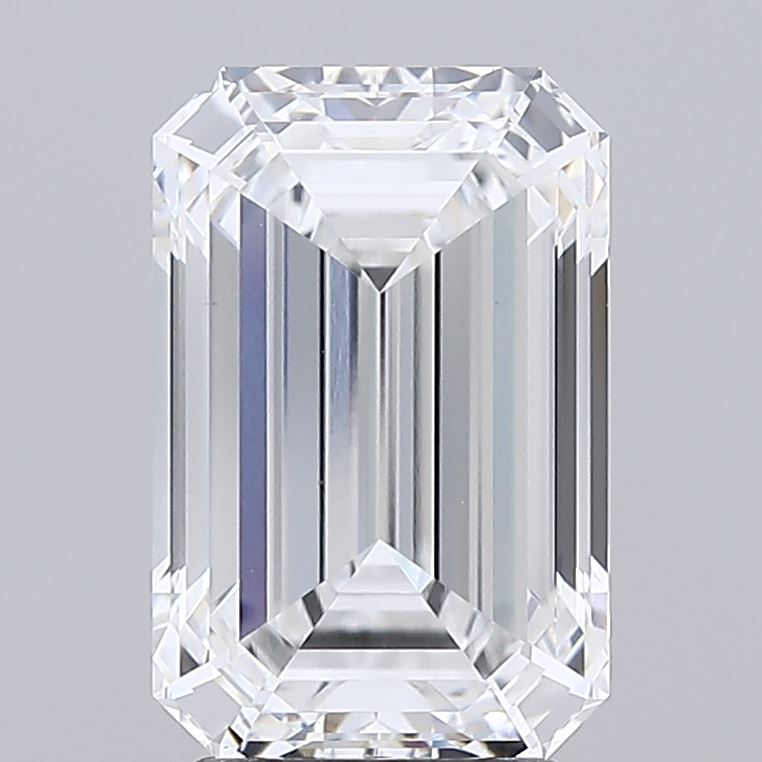 3.3 An emerald-cut diamond with symmetrical lines and sharp facets, reflecting light and exhibiting a clear, radiant appearance. Set against a plain gray background.