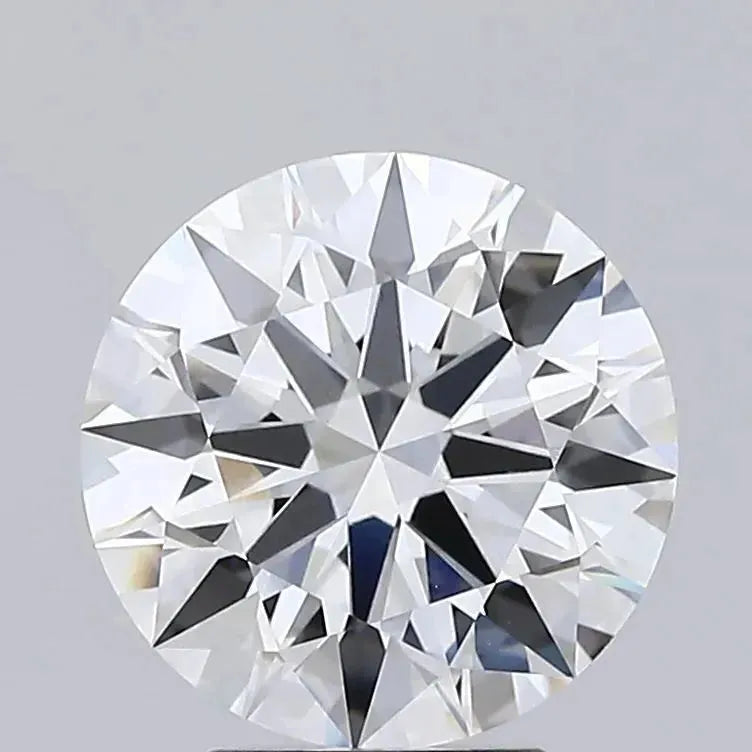 3.54 A close up of a round brilliant cut diamond against a grey background.