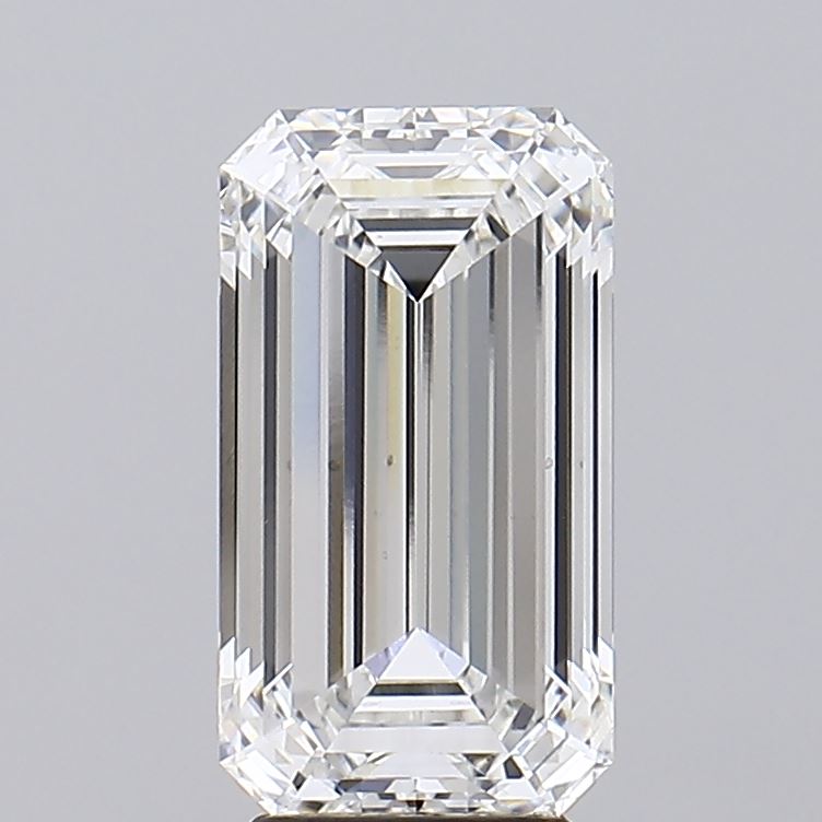 3.8 A close-up of a sparkling emerald cut diamond against a gray background.