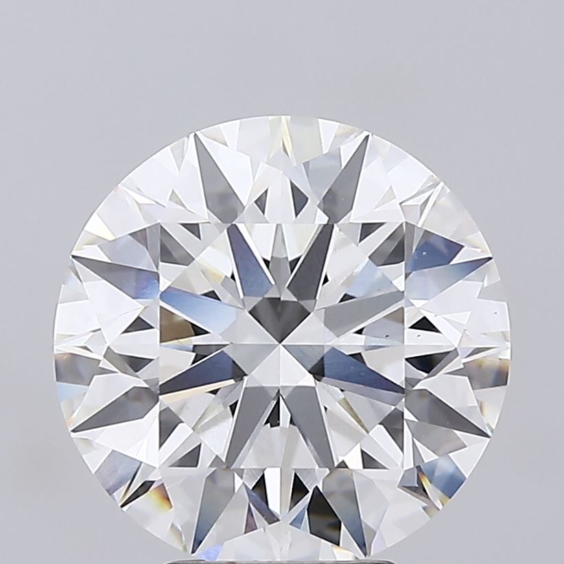 5.56 Close-up of a round cut diamond against a gray background.