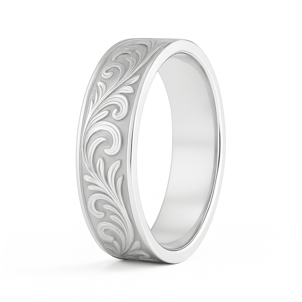 Silver ring with intricate floral engraving on a white background