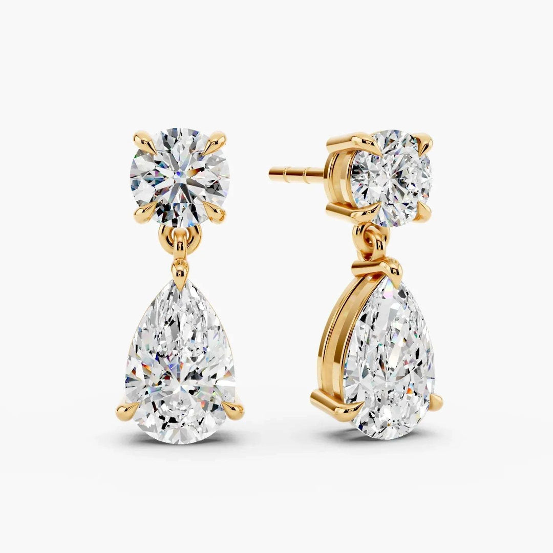 Angled view of 5ct lab grown diamond drop earrings in 14k yellow gold, IGI certified colorless diamonds with secure butterfly backing