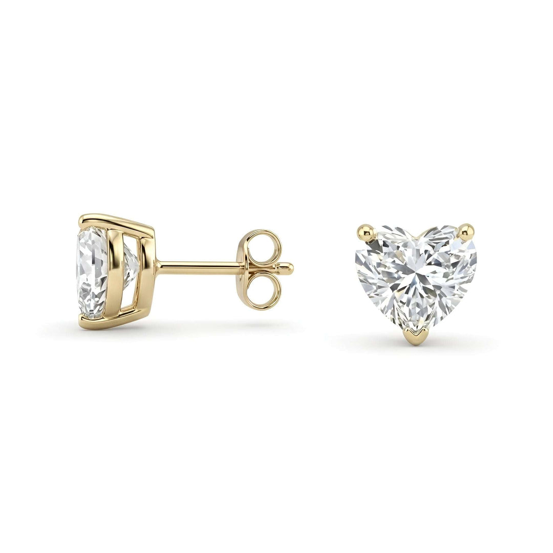 Close-up of lab-grown diamond heart earrings set in 14k gold with four-prong basket setting
