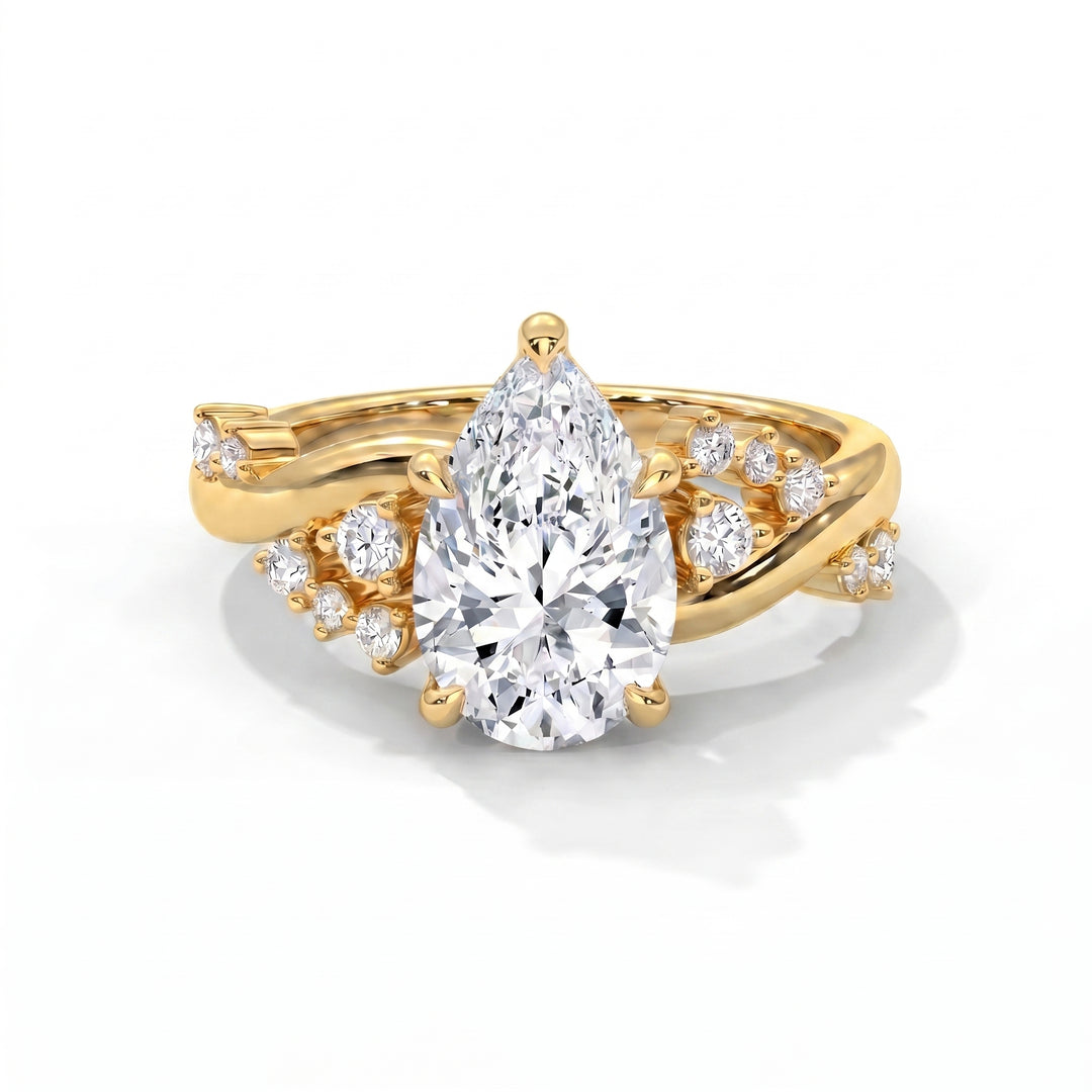 Eden Setting in 14K Yellow Gold with pear-cut center stone and scattered diamond twisted band
