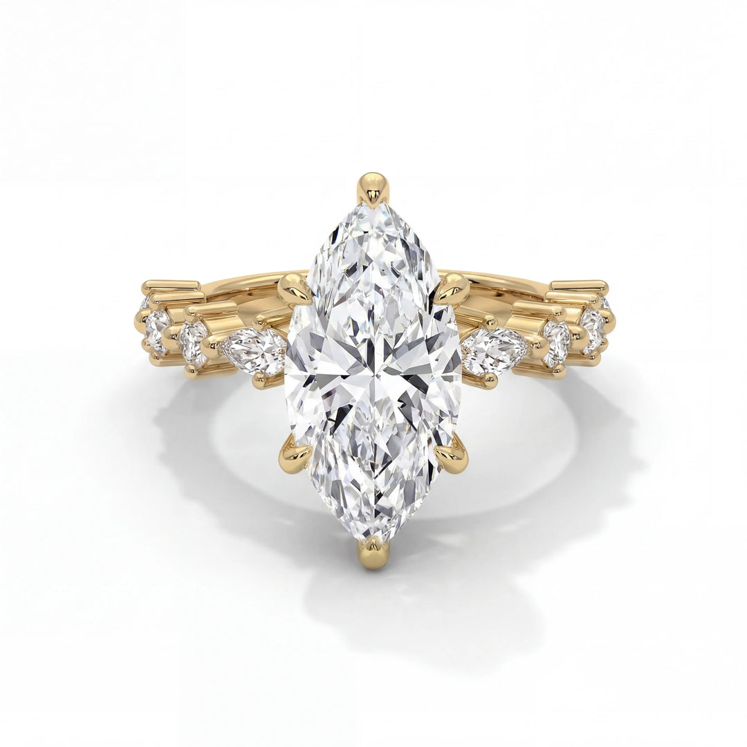 Gold ring with a large pear-shaped diamond and smaller diamonds on a white background