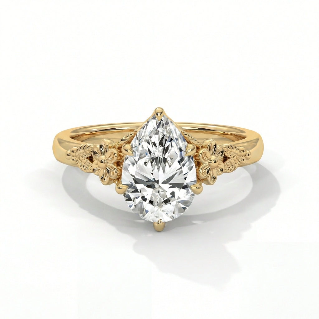 Gold ring with a pear-shaped diamond on a white background