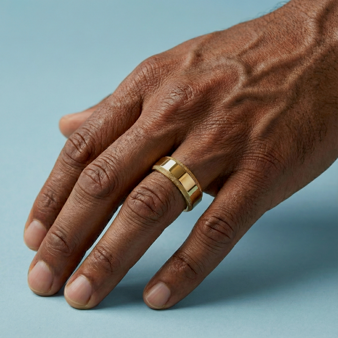 Hand wearing a wooden ring on a gray background