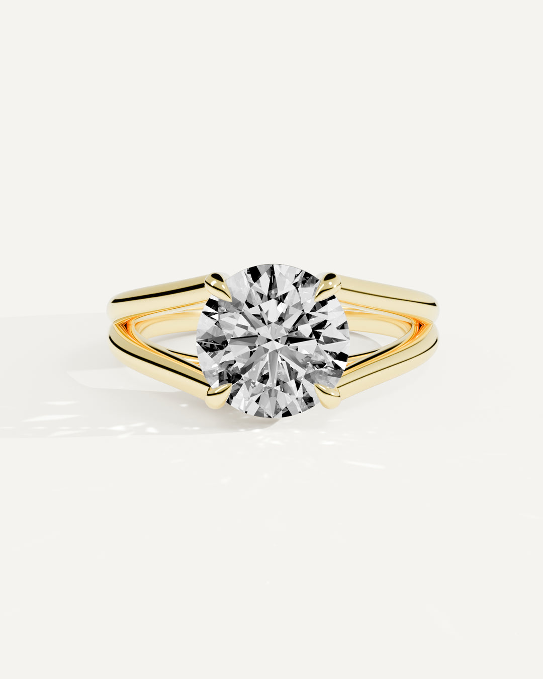 Seco Solitaire Setting, Round center stone in yellow gold, resting front view