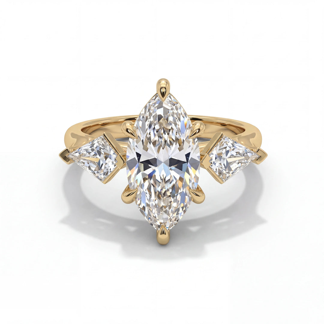 Gold ring with a large pear-shaped diamond and two smaller diamonds on a white background