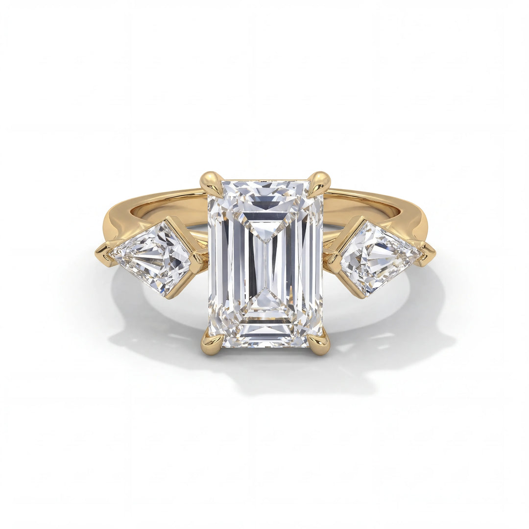 Gold ring with emerald-cut diamond and two smaller diamonds on a white background