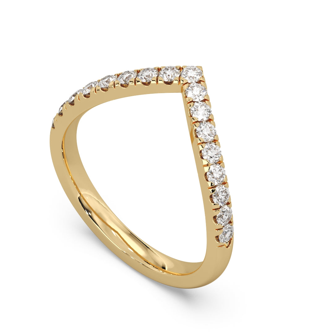 A gold V-shaped ring with a row of sparkling diamonds along the top, set against a white background, conveying elegance and luxury.