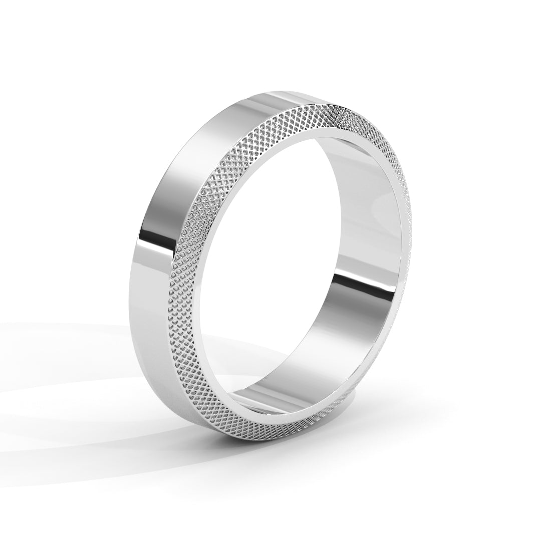 Silver ring with textured design on a white background
