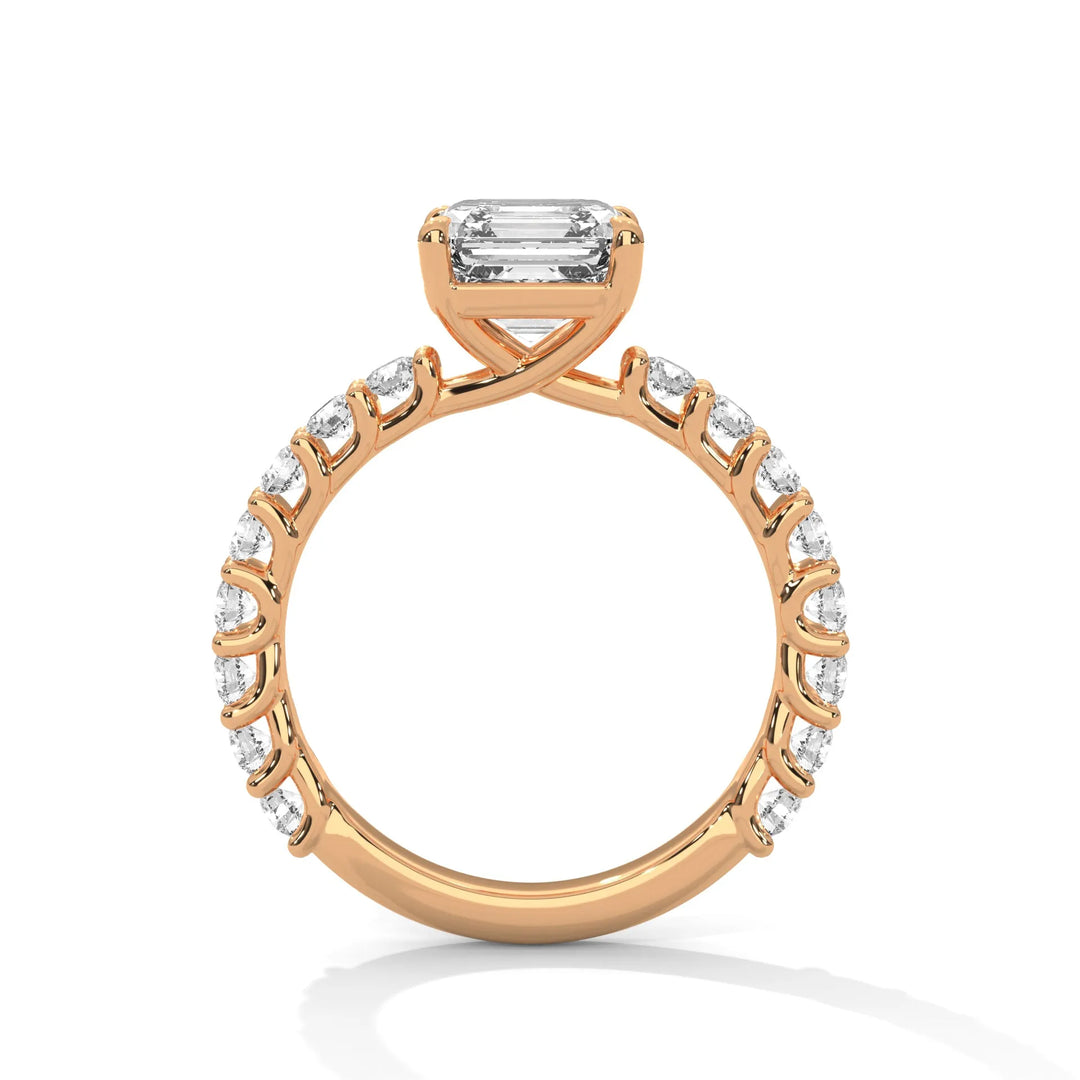 A rose gold engagement ring with a diamond center in a bubble setting, crafted from 14k gold and featuring an asscher shape.