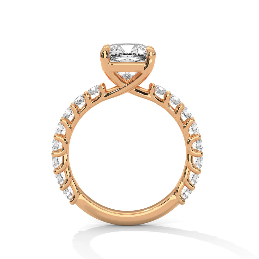 A rose gold engagement ring with a diamond center in a bubble setting, crafted from 14k gold and featuring an cushion shape.