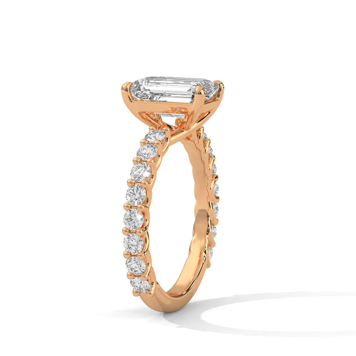 An elegant emerald diamond engagement ring crafted in 14k rose gold, highlighted by a bubble setting for a captivating 3D appearance.