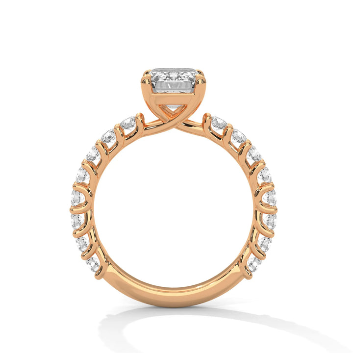 A rose gold engagement ring with a diamond center in a bubble setting, crafted from 14k gold and featuring an emerald shape.