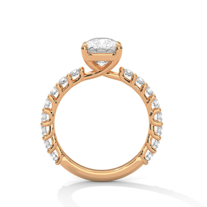 A rose gold engagement ring with a diamond center in a bubble setting, crafted from 14k gold and featuring an long cushion shape.