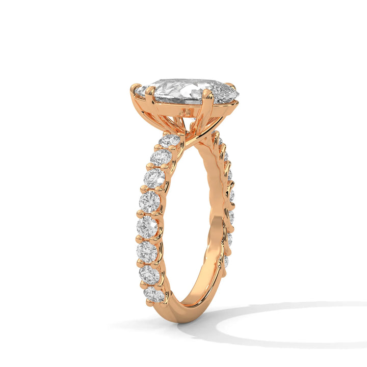 A rose gold engagement ring with a diamond center in a bubble setting, crafted from 14k gold and featuring an pear shape.