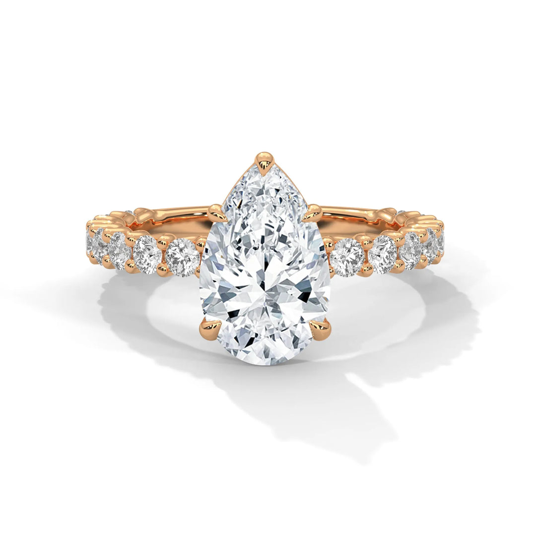 A stunning pear cut diamond engagement ring in a bubble setting, crafted from 14k rose gold for a luxurious touch.