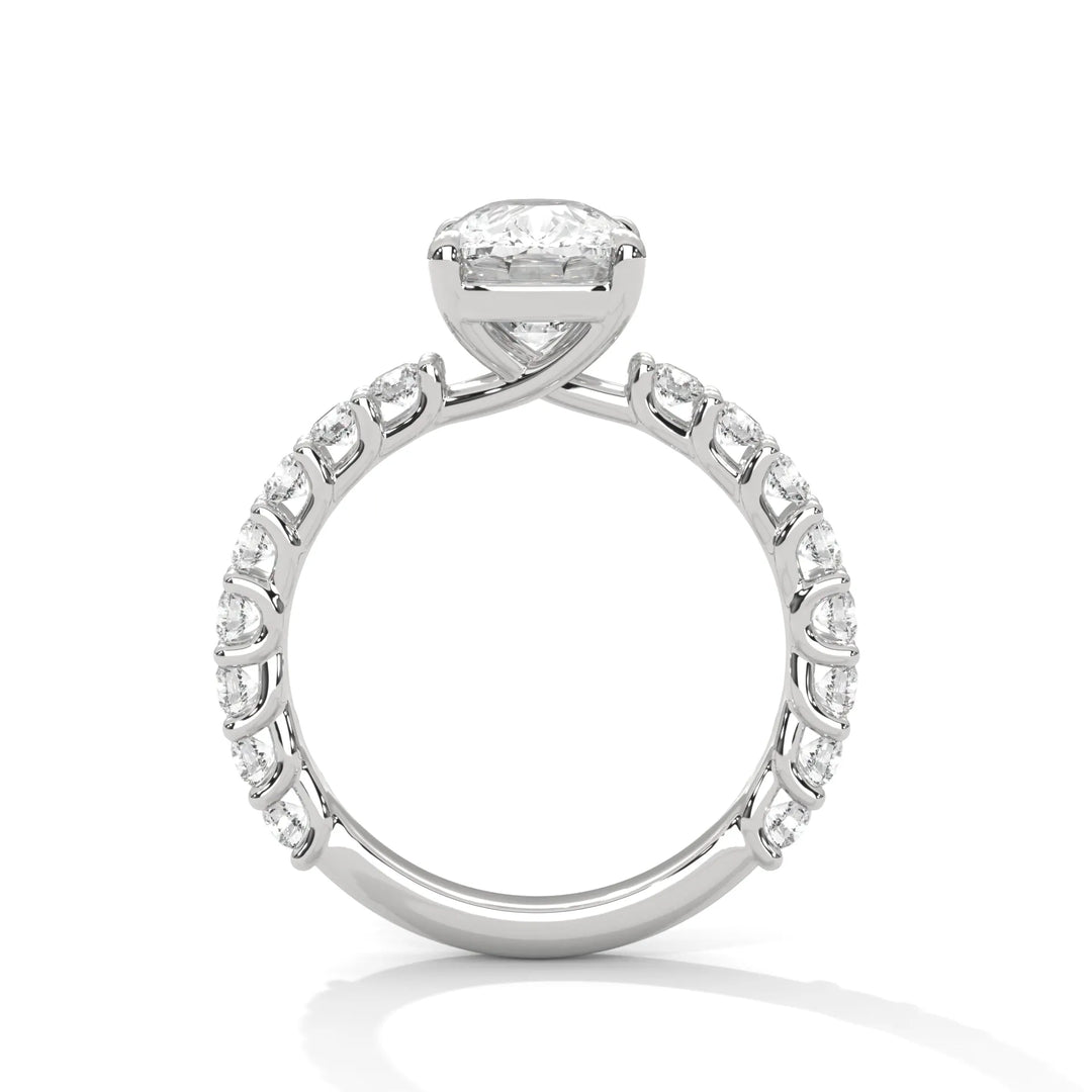 A white gold engagement ring with a diamond center in a bubble setting, crafted from 14k gold and featuring an long cushion shape.