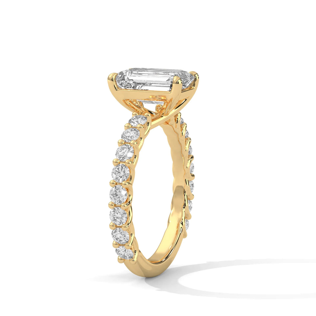 An elegant emerald diamond engagement ring crafted in 14k yellow gold, highlighted by a bubble setting for a captivating 3D appearance.