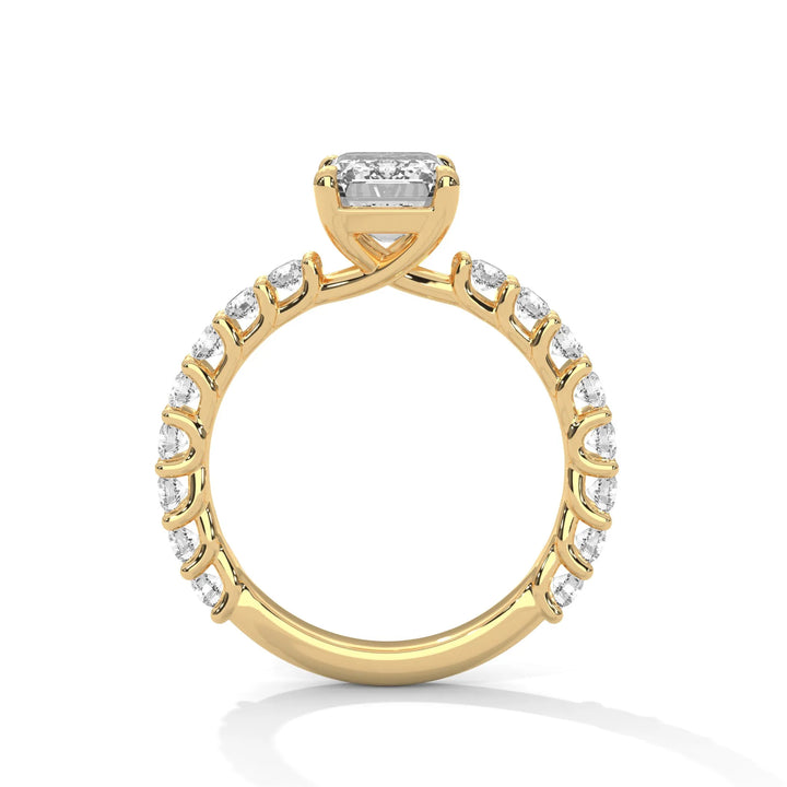 A yellow gold engagement ring with a diamond center in a bubble setting, crafted from 14k gold and featuring an emerald shape.