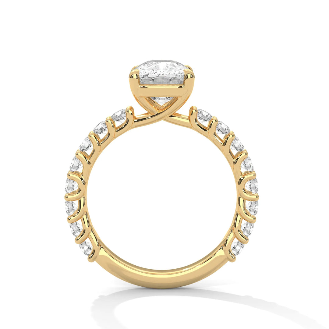 A yellow gold engagement ring with a diamond center in a bubble setting, crafted from 14k gold and featuring an long cushion shape.